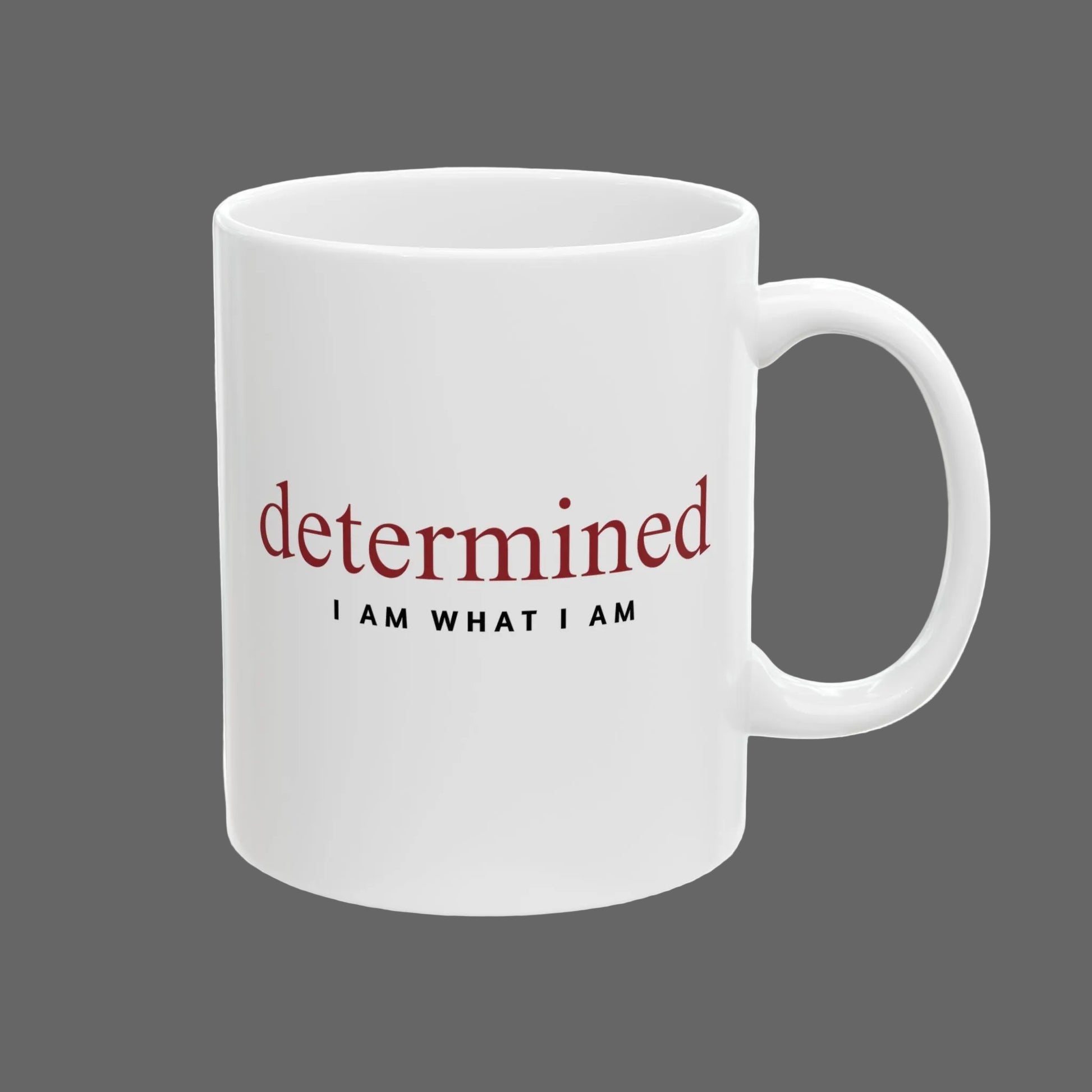 White mug with motivational text 'determined I AM WHAT I AM' on a white background