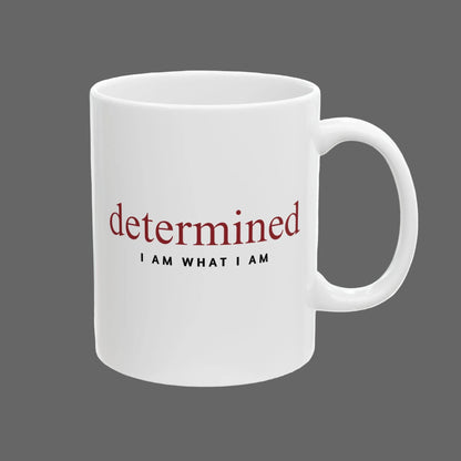 White mug with motivational text 'determined I AM WHAT I AM' on a white background