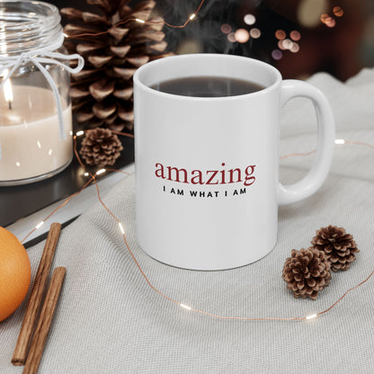 White mug with 'amazing I AM WHAT I AM' text on a table with decorative items.