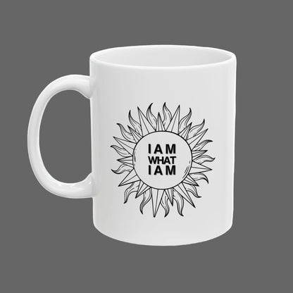 White mug with sunflower design and 'I AM WHAT I AM' text on a white background