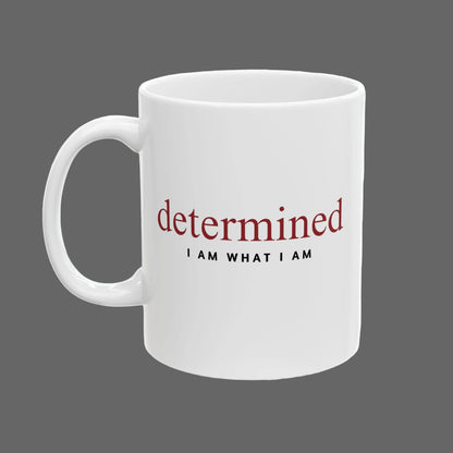 White mug with motivational text 'determined I AM WHAT I AM' on a white background