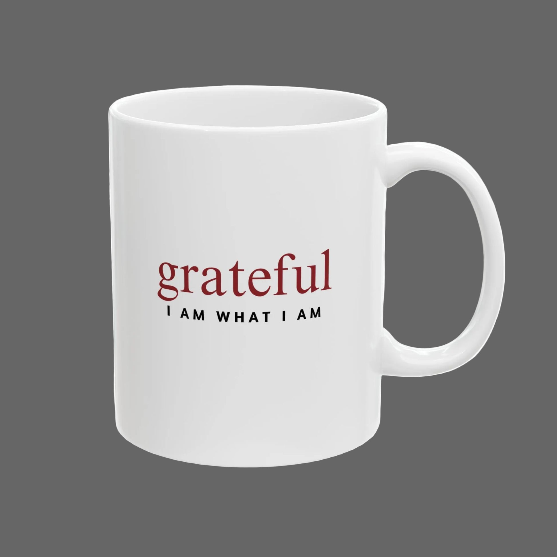 White mug with 'grateful I AM WHAT I AM' text on a white background