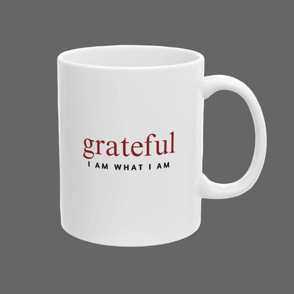 White mug with 'grateful I AM WHAT I AM' text on a white background