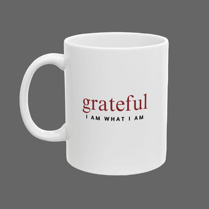 White mug with 'grateful I AM WHAT I AM' text on a white background